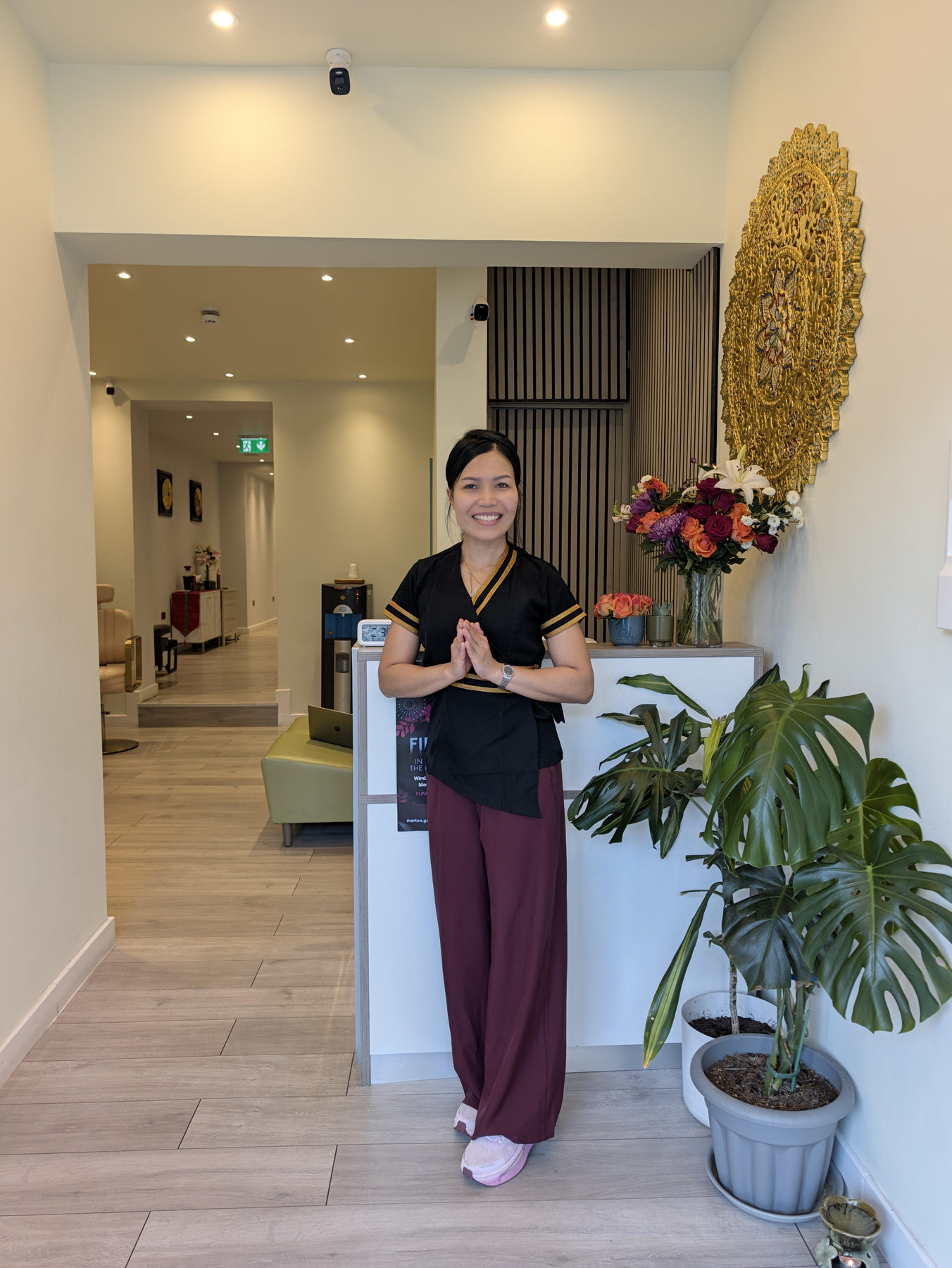 The owner welcoming guests at Golden Touch Thai Massage